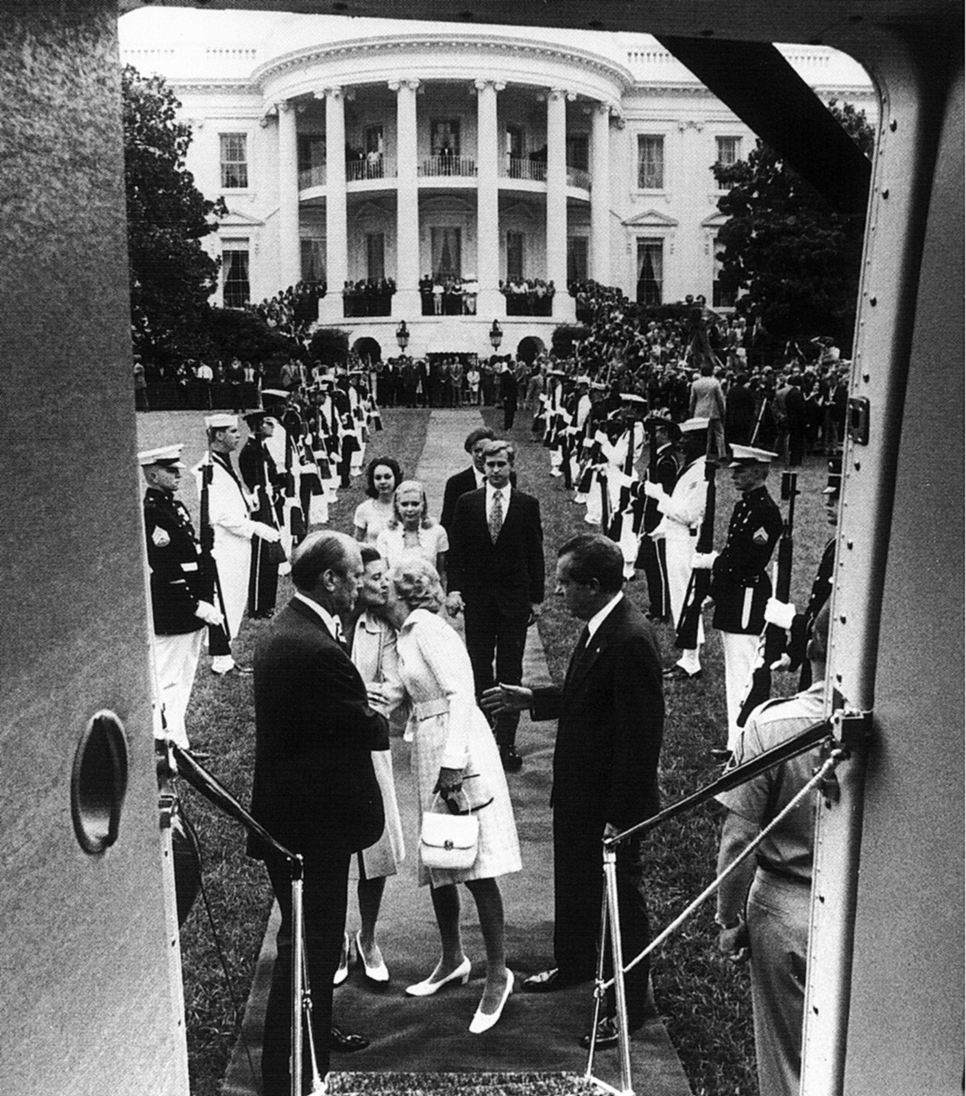 President Nixon waves from the steps of the Army One helicopter as he departs the White House, August 9, 1974
