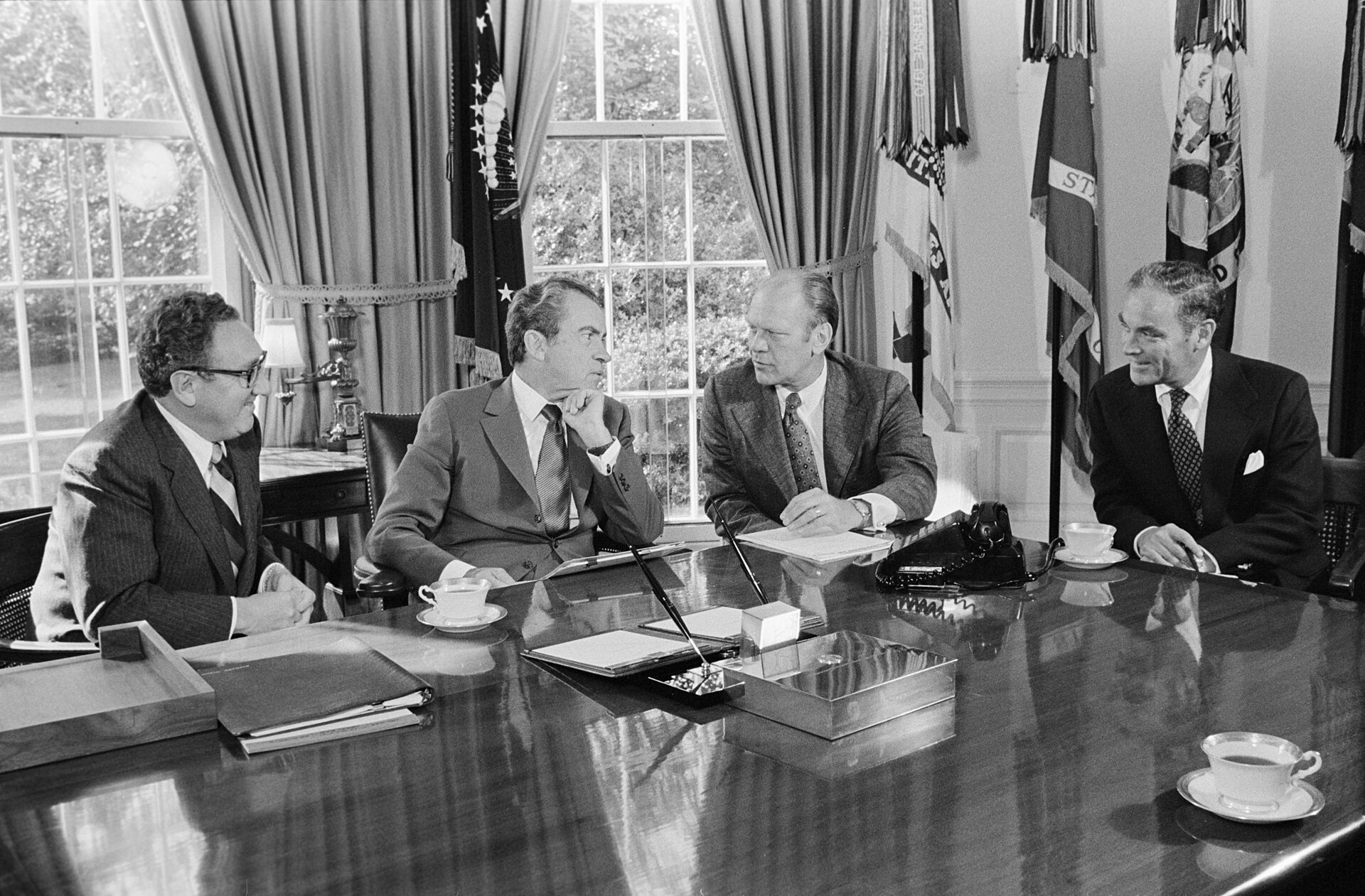 President Nixon at his Oval Office desk in a meeting with Henry Kissinger, Alexander Haig, and Gerald Ford